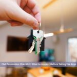 Hand holding the keys to a new apartment, illustrating the flat possession checklist to follow before taking the keys
